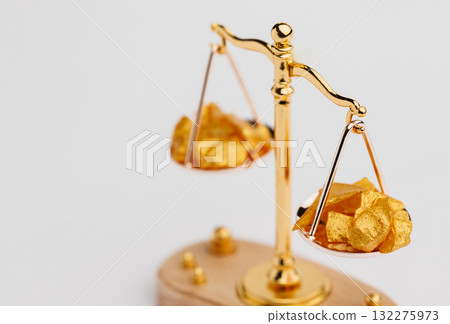 Beautiful Golden Balance Scales with little pieces of gold. Gold cost climbing up. Finance, gold theme 132275973