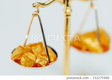 Beautiful Golden Balance Scales with little pieces of gold. Gold cost climbing up. Finance, gold theme 132275980
