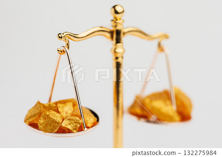 Beautiful Golden Balance Scales with little pieces of gold. Gold cost climbing up. Finance, gold theme 132275984