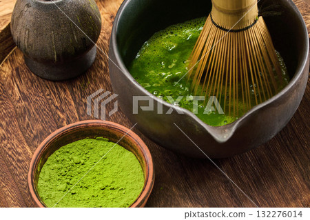 Matcha Preparation Scene. A traditional matcha tea whisking scene featuring vibrant green tea 132276014