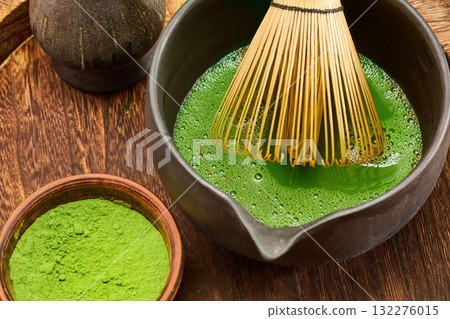 Matcha Tea Ceremony. A traditional matcha tea setup with whisk, bowl, and green tea powder 132276015