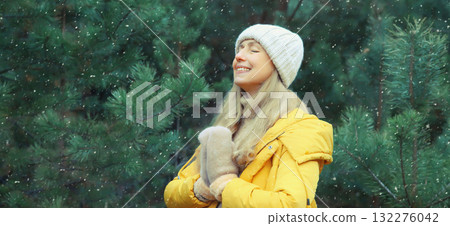 Calm relaxed healthy woman meditates in winter forest, girl practicing doing yoga exercises outdoors 132276042