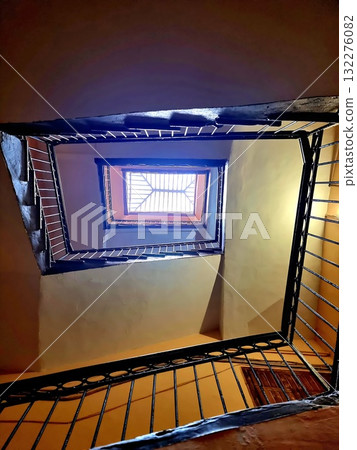 Looking straight up the center of a spiral staircase well in an old St. Petersburg building. 132276082