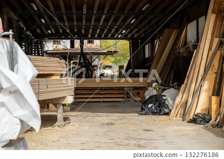 Interior of woodworking workshop with stacked timber boards and carpentry materials 132276186
