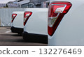 The beds of clean identical pickup trucks in the parking lot of a car delivery service 132276469