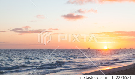Soft sunset paints the ocean with warm gold and pink hues. Dominican Republic 132276581