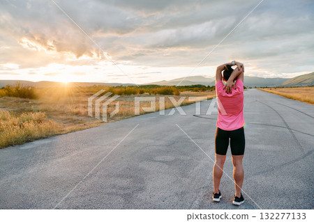 Athlete Stretching at Sunset After Intense Run Athlete Stretching at Sunset After Intense Run 132277133