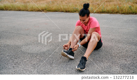 Athletic Woman Preparing for Morning Run 132277218