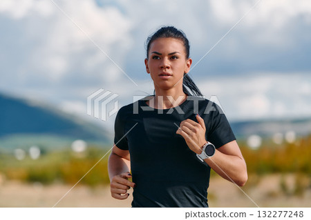 Determined Athlete Running in the Sun amidst Beautiful Nature Determined Athlete Running in the Sun amidst Beautiful Nature 132277248