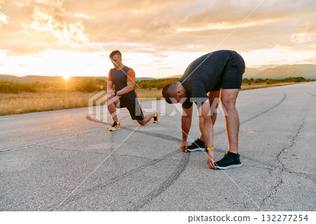 Sunset Stretch Friends Warm Up and Stretch After Challenging Run. Sunset Stretch Friends Warm Up and Stretch After Challenging Run. 132277254