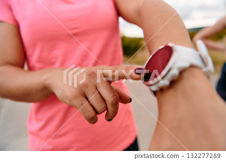 Close Up Woman Analyzing Workout Data on Smartwatch Post Run. 132277289
