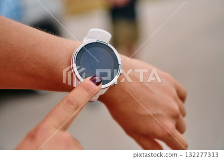 Close Up Woman Analyzing Workout Data on Smartwatch Post Run. 132277313