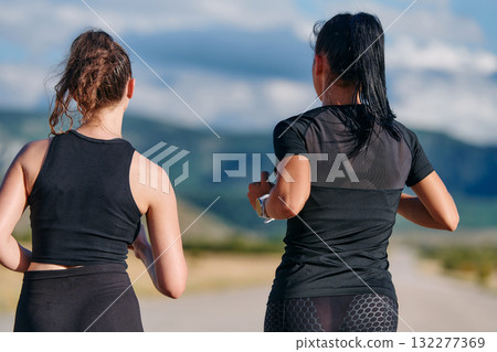 Two Friends Running Together on a Sunny Day, Preparing for Life's Extreme Challenges Two Friends Running Together on a Sunny Day, Preparing for Life's Extreme Challenges 132277369