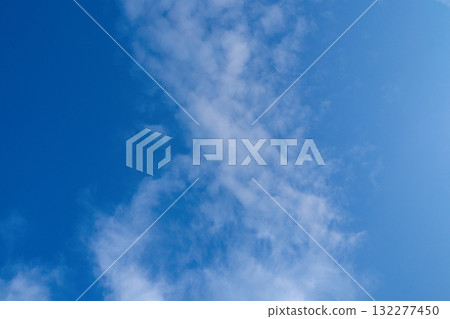 White clouds on blue sky. Fluffy cirrus clouds in summer sunny day. Nature cloudscape background. White clouds on blue sky. Fluffy cirrus clouds in summer sunny day. Nature cloudscape background. 132277450