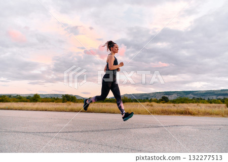 Determined Athlete Running in the Sun amidst Beautiful Nature Determined Athlete Running in the Sun amidst Beautiful Nature 132277513