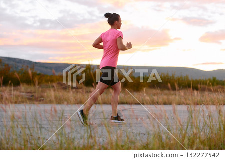 Determined Athlete Running in the Sun amidst Beautiful Nature Determined Athlete Running in the Sun amidst Beautiful Nature 132277542