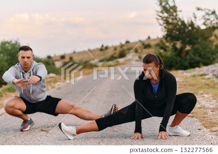 Romantic Couple Stretching Together After an Intense Morning Run 132277566