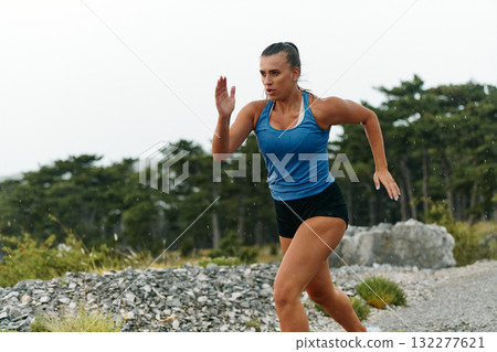 Unstoppable: A Determined Athlete Trains Through the Rain in Pursuit of Marathon Glory Unstoppable: A Determined Athlete Trains Through the Rain in Pursuit of Marathon Glory 132277621