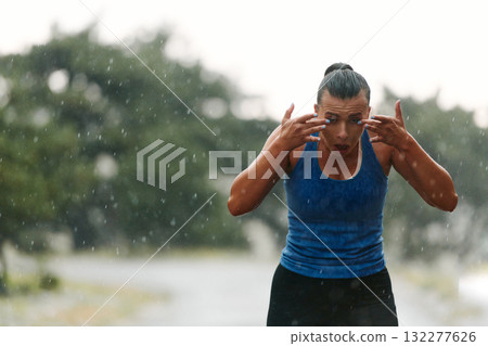 Unstoppable: A Determined Athlete Trains Through the Rain in Pursuit of Marathon Glory 132277626