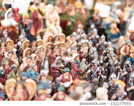 Nativity figurines and animals on a crowded market stall. 132277650