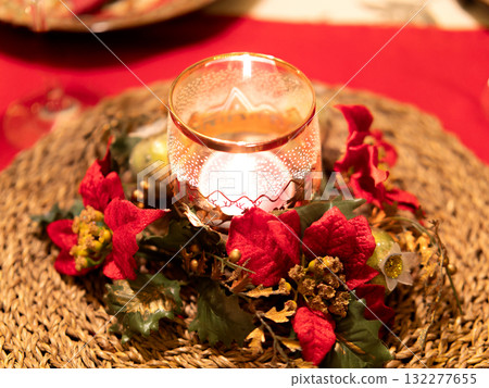 Christmas candlelight centerpiece on a red table. 132277655