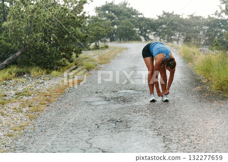 Determined Woman Athlete Preparing for Morning Run 132277659
