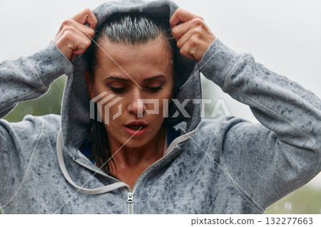 Woman Resting in the Rain After Intense Run Woman Resting in the Rain After Intense Run 132277663