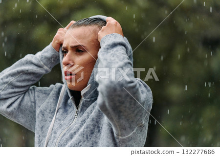 Woman Resting in the Rain After Intense Run Woman Resting in the Rain After Intense Run 132277686