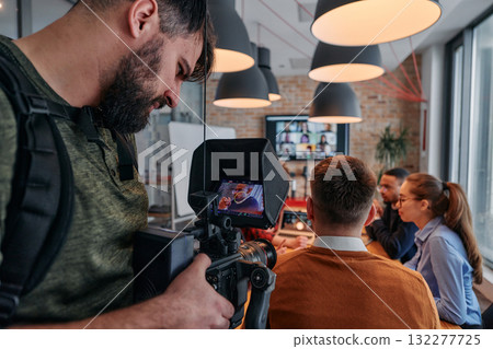 Capturing Corporate Dynamics: Videographer Films Business Meeting in Modern Office. Capturing Corporate Dynamics: Videographer Films Business Meeting in Modern Office. 132277725