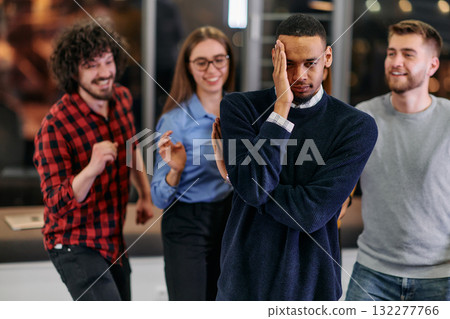 A group of young business people have fun playing interesting games while taking a break from work in a modern office. Selective focus A group of young business people have fun playing interesting games while taking a break from work in a modern office. Selective focus 132277766