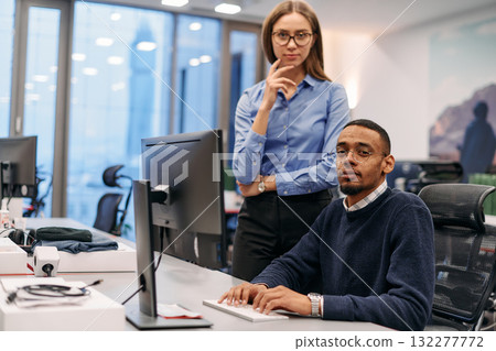 Digital Collaboration: Blonde Businesswoman and African American Partner Reviewing Documents Online Digital Collaboration: Blonde Businesswoman and African American Partner Reviewing Documents Online 132277772