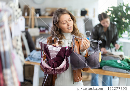Young woman chooses underwear in clothing store 132277893