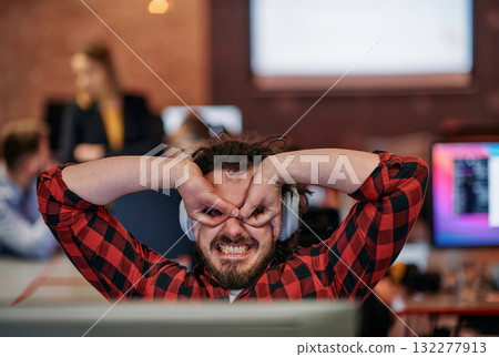 Joyful Collaboration: A Man Embracing Remote Work with Enthusiastic Gestures in a Coworking Space. Joyful Collaboration: A Man Embracing Remote Work with Enthusiastic Gestures in a Coworking Space. 132277913