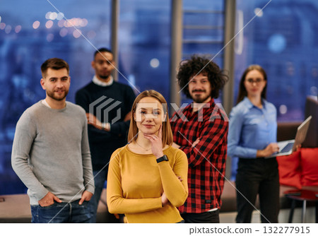 Portrait of successful creative business team looking at camera and smiling. Diverse business people standing together at startup. Selective focus Portrait of successful creative business team looking at camera and smiling. Diverse business people standing together at startup. Selective focus 132277915
