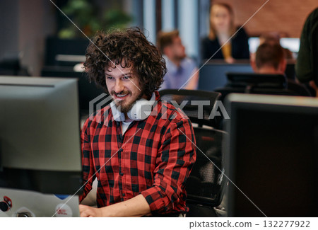 Focused Programmer With Afro Hairstyle in Plaid Shirt Working on Computer in Office Environment Focused Programmer With Afro Hairstyle in Plaid Shirt Working on Computer in Office Environment 132277922