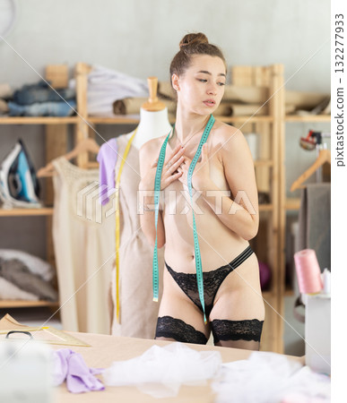 Young woman seamstress topless in workshop Young woman seamstress topless in workshop 132277933