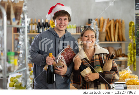 Couple man and woman choosing groceries in store 132277968