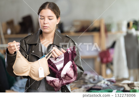 Uncertain young girl choosing bra in clothing store Uncertain young girl choosing bra in clothing store 132278006