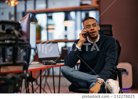 After Hours Reflection: African American Man Using Smartphone in Office. 132278025