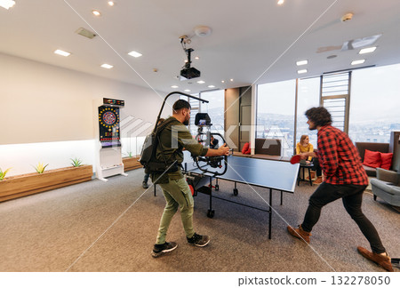 Videographer Captures Business Colleagues Playing Table Tennis During Break 132278050