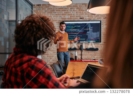 In a corporate setting businessman leads a meeting, passionately presenting a business plan to his attentive team, fostering collaboration and strategic thinking In a corporate setting businessman leads a meeting, passionately presenting a business plan to his attentive team, fostering collaboration and strategic thinking 132278078
