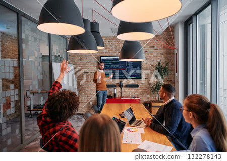 In a corporate setting businessman leads a meeting, passionately presenting a business plan to his attentive team, fostering collaboration and strategic thinking 132278143