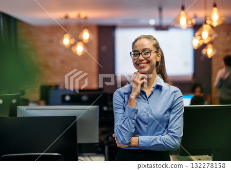 Empowered Elegance: A Confident Businesswoman Radiates Success in Front of Her Office. 132278158