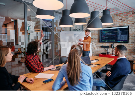 In a corporate setting businessman leads a meeting, passionately presenting a business plan to his attentive team, fostering collaboration and strategic thinking In a corporate setting businessman leads a meeting, passionately presenting a business plan to his attentive team, fostering collaboration and strategic thinking 132278166