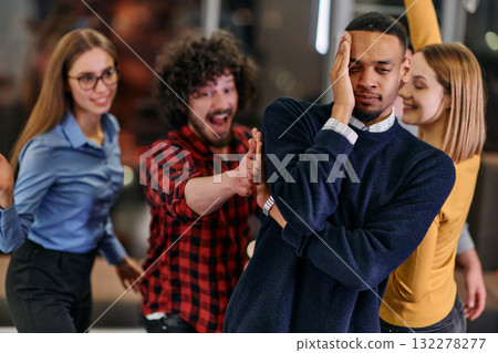 A group of young business people have fun playing interesting games while taking a break from work in a modern office. Selective focus  132278277