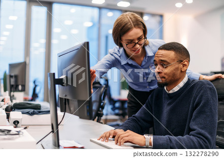 Digital Collaboration: Blonde Businesswoman and African American Partner Reviewing Documents Online Digital Collaboration: Blonde Businesswoman and African American Partner Reviewing Documents Online 132278290