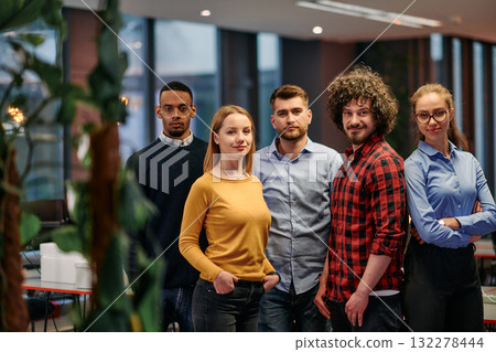 Portrait of successful creative business team looking at camera and smiling. Diverse business people standing together at startup. Selective focus  132278444