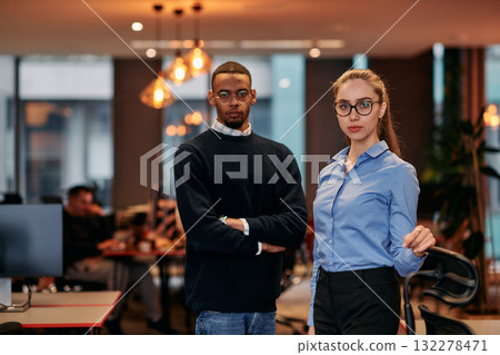 Digital Collaboration: Blonde Businesswoman and African American Partner Reviewing Documents Online 132278471