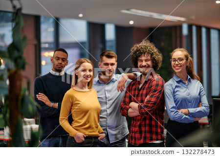 Portrait of successful creative business team looking at camera and smiling. Diverse business people standing together at startup. Selective focus Portrait of successful creative business team looking at camera and smiling. Diverse business people standing together at startup. Selective focus 132278473