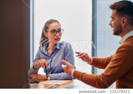 Businesswoman Leading Discussion in Modern Office Setting Businesswoman Leading Discussion in Modern Office Setting 132278521